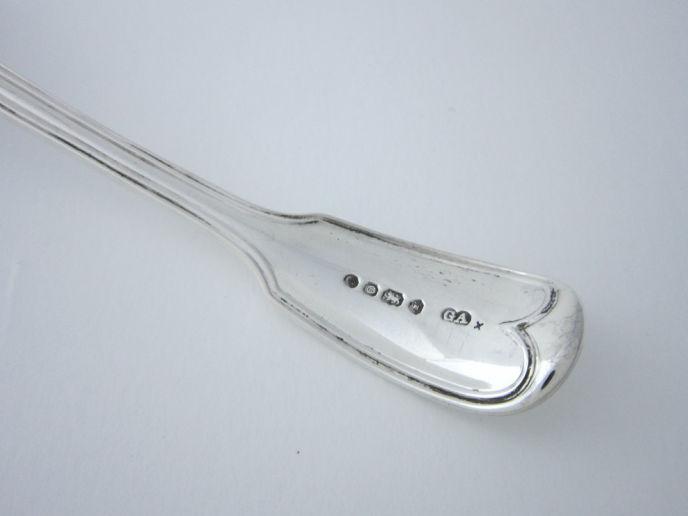 A Victorian sterling silver sifter spoon featuring a pierced scrolled bowl design and a Fiddle and Thread pattern handle. View V