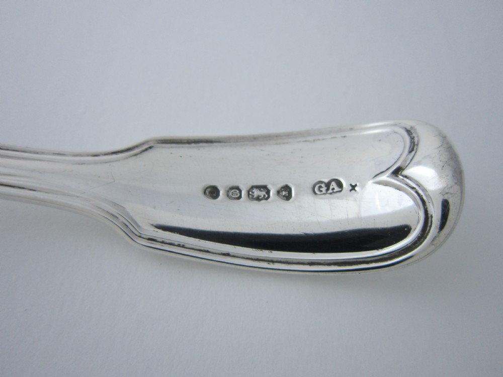 A Victorian sterling silver sifter spoon featuring a pierced scrolled bowl design and a Fiddle and Thread pattern handle. View VI