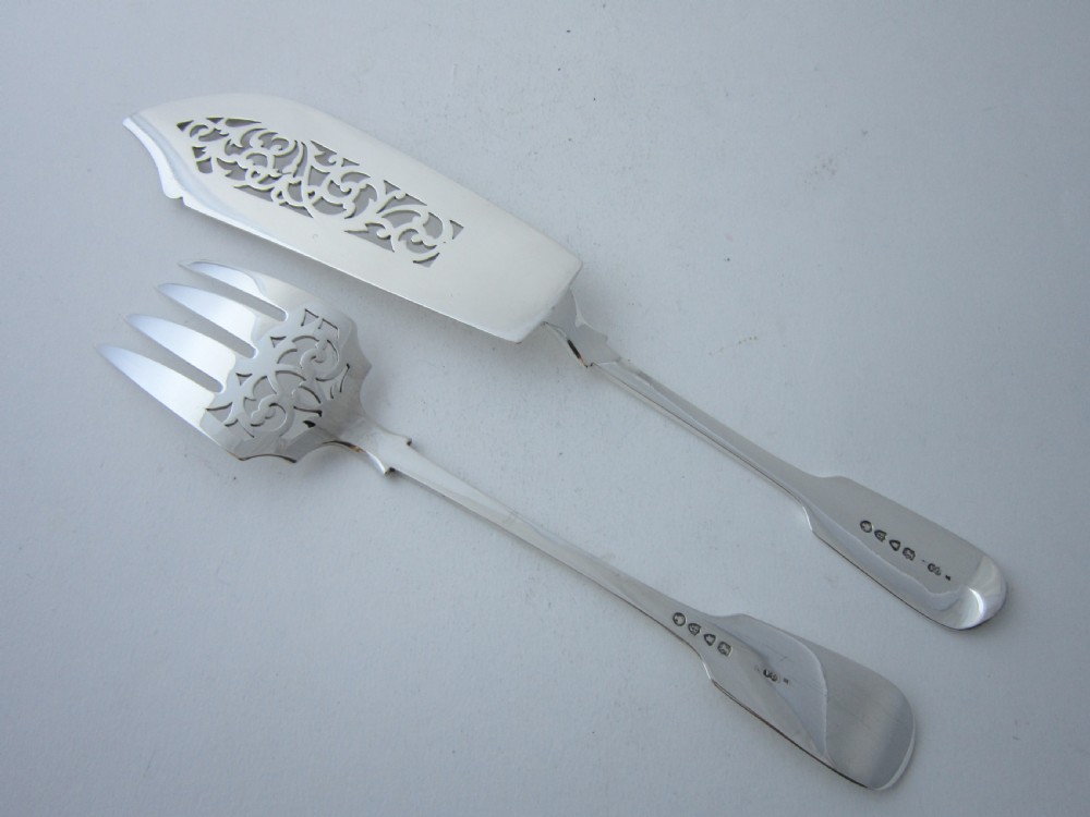 A pair of Victorian sterling silver fish servers featuring a pierced scrollwork knife blade and a four-tine fork with fiddle pattern handles. View II