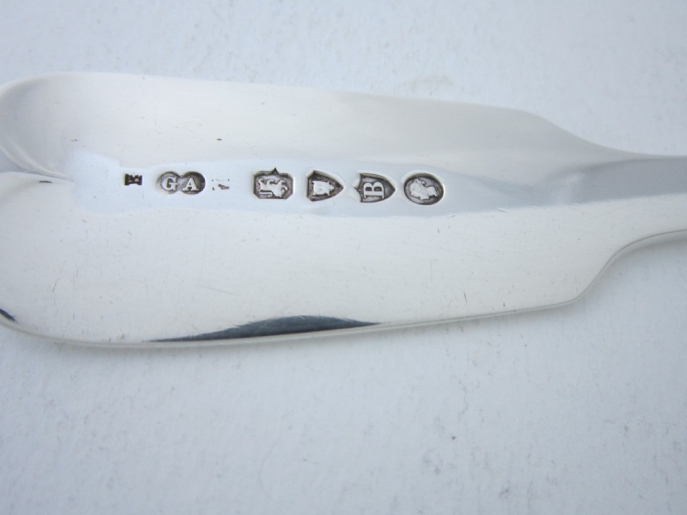 A pair of Victorian sterling silver fish servers featuring a pierced scrollwork knife blade and a four-tine fork with fiddle pattern handles. View IV