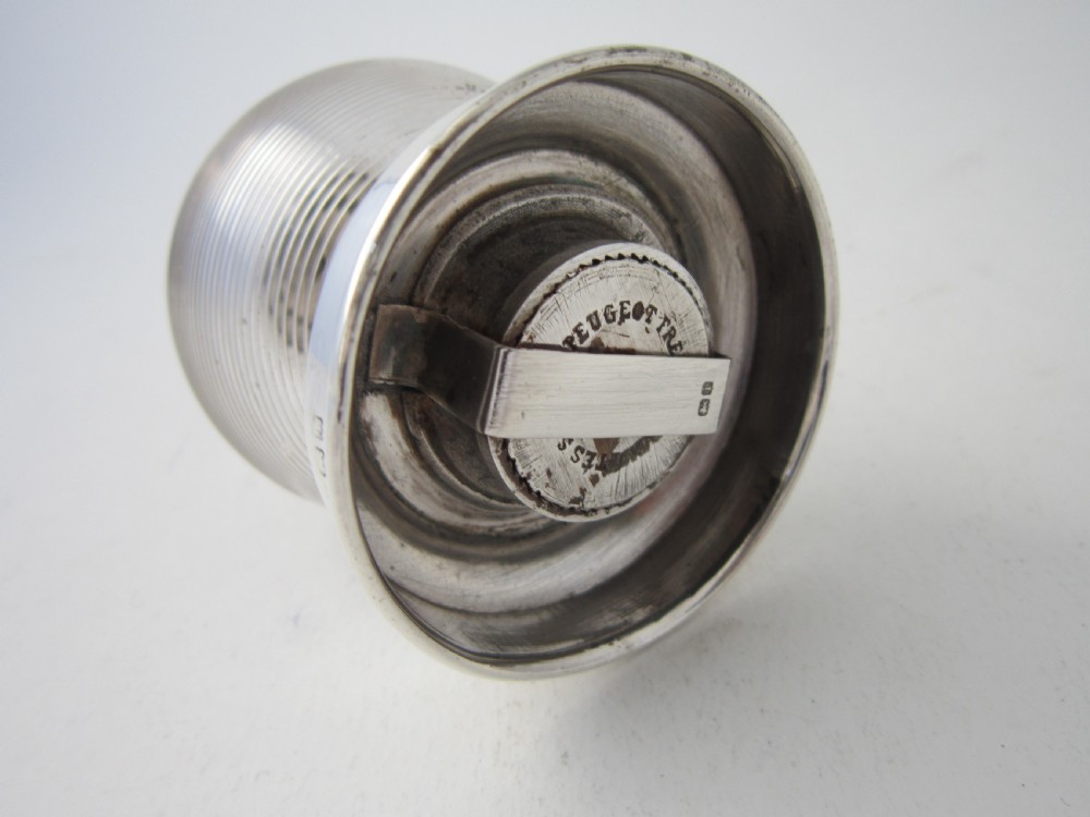 An Edwardian sterling silver and ribbed clear glass pepper grinder with hallmarked silver mounts on the top and base. View IV
