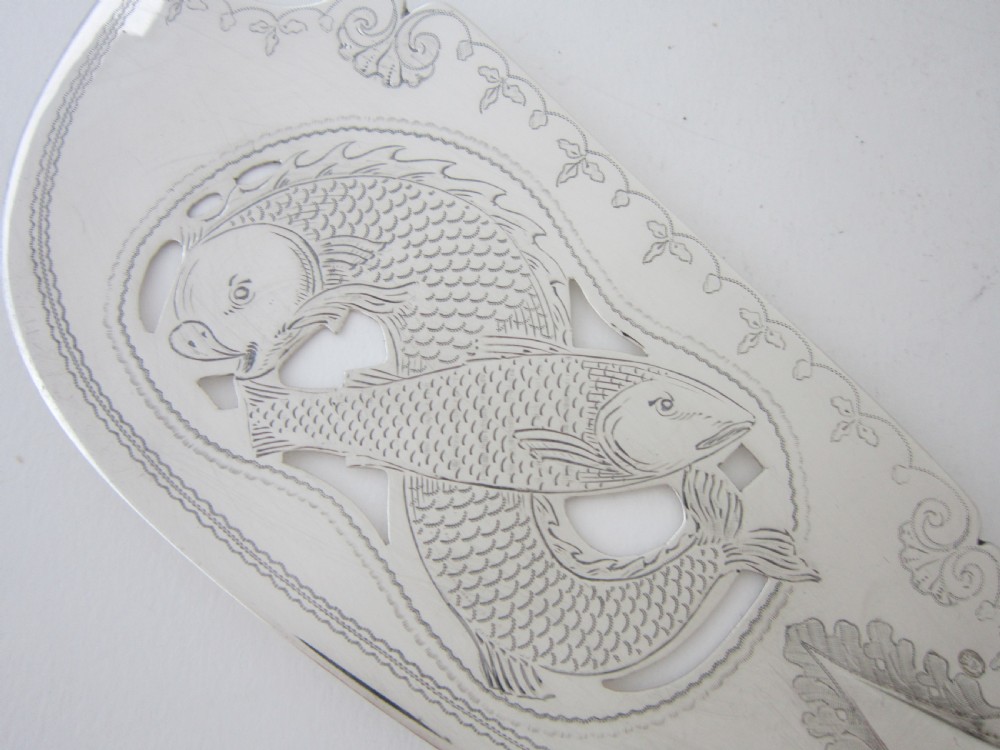 An Irish George IV sterling silver fish slice with a pierced fish motif on the blade and a fiddle pattern handle. View II