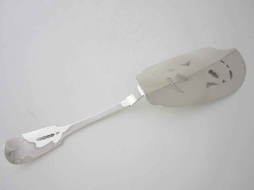 An Irish George IV sterling silver fish slice with a pierced fish motif on the blade and a fiddle pattern handle. View V