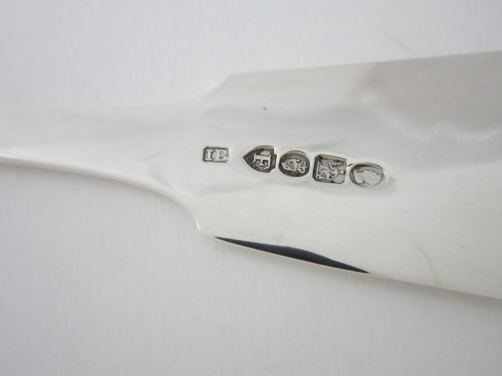 An Irish George IV sterling silver fish slice with a pierced fish motif on the blade and a fiddle pattern handle. View VI