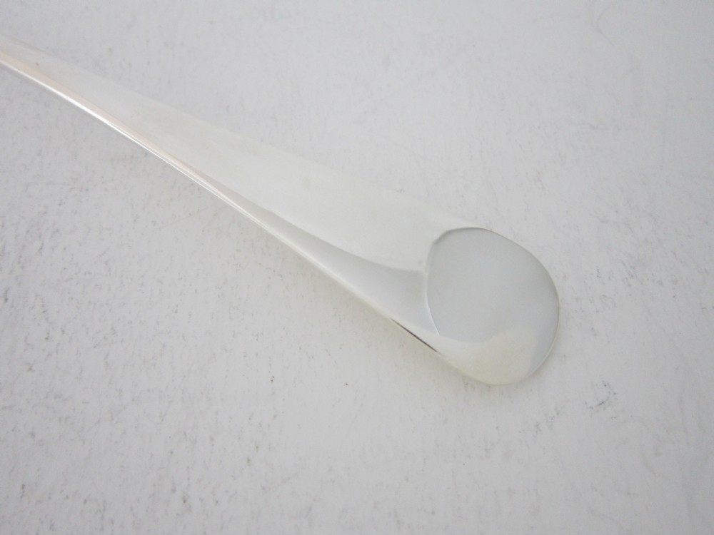 A polished sterling silver Stilton scoop featuring a spade-shaped blade and a plain Old English pattern handle. View III