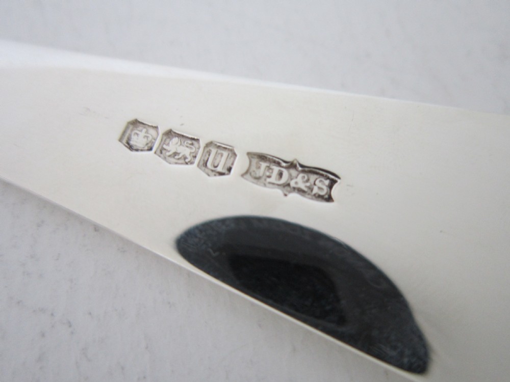 A polished sterling silver Stilton scoop featuring a spade-shaped blade and a plain Old English pattern handle. View VII