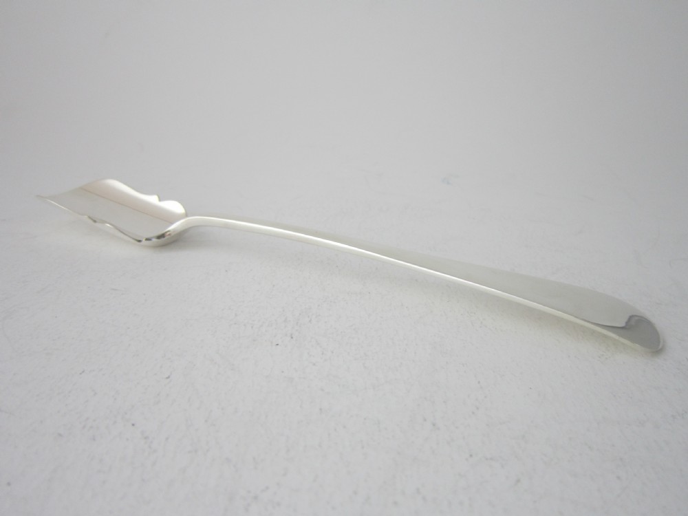 A polished sterling silver Stilton scoop featuring a spade-shaped blade and a plain Old English pattern handle. View VIII