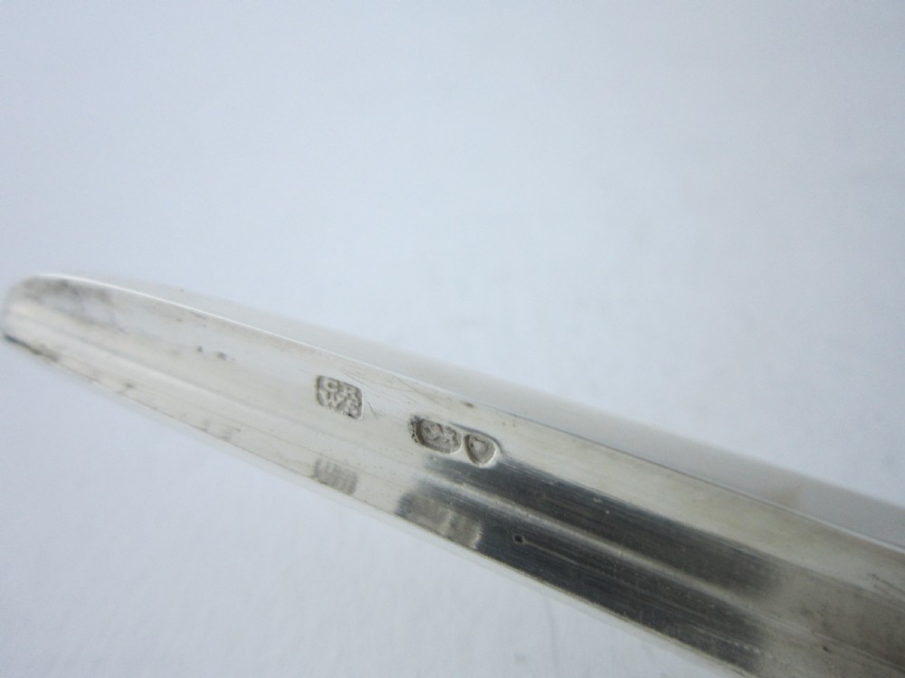 A pair of Victorian sterling silver grape scissors with grapevine-textured handles, resting inside an open fitted presentation case. View VIII