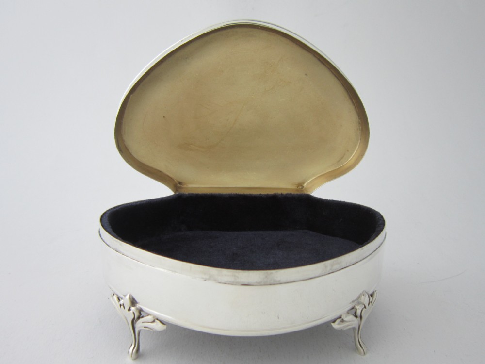 An antique George V sterling silver trinket box with a smooth shaped hinged lid, beaded trim, and four raised feet. View II