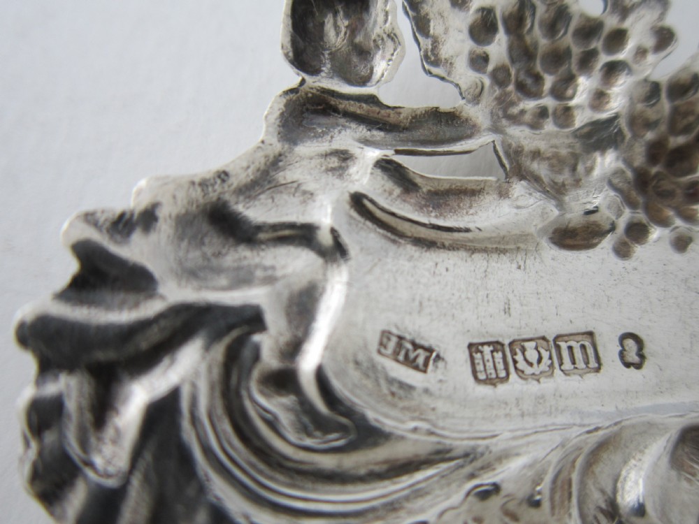 A pair of Scottish George III sterling silver decanter labels engraved with Madeira and Port, featuring relief motifs of cherubs, grapes, and scrollwork on hanging chains. View XII