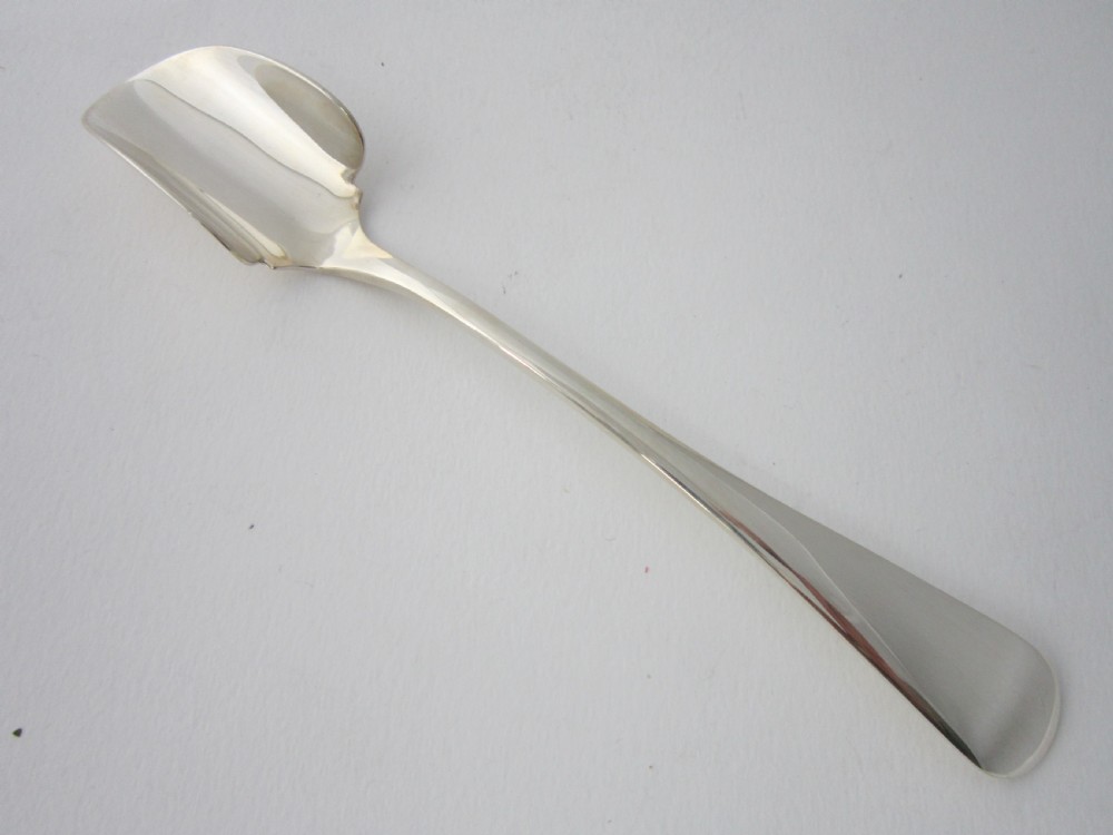 An antique sterling silver Stilton scoop featuring a curved spade-shaped blade and a smooth Old English pattern handle.