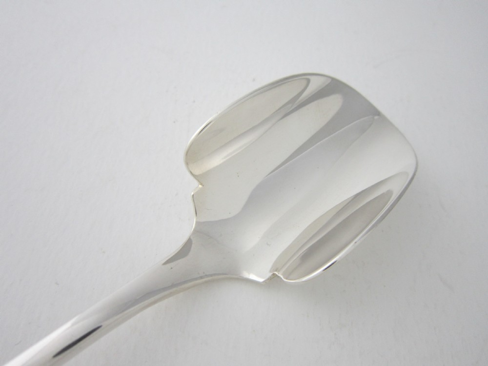 An antique sterling silver Stilton scoop featuring a curved spade-shaped blade and a smooth Old English pattern handle. View III