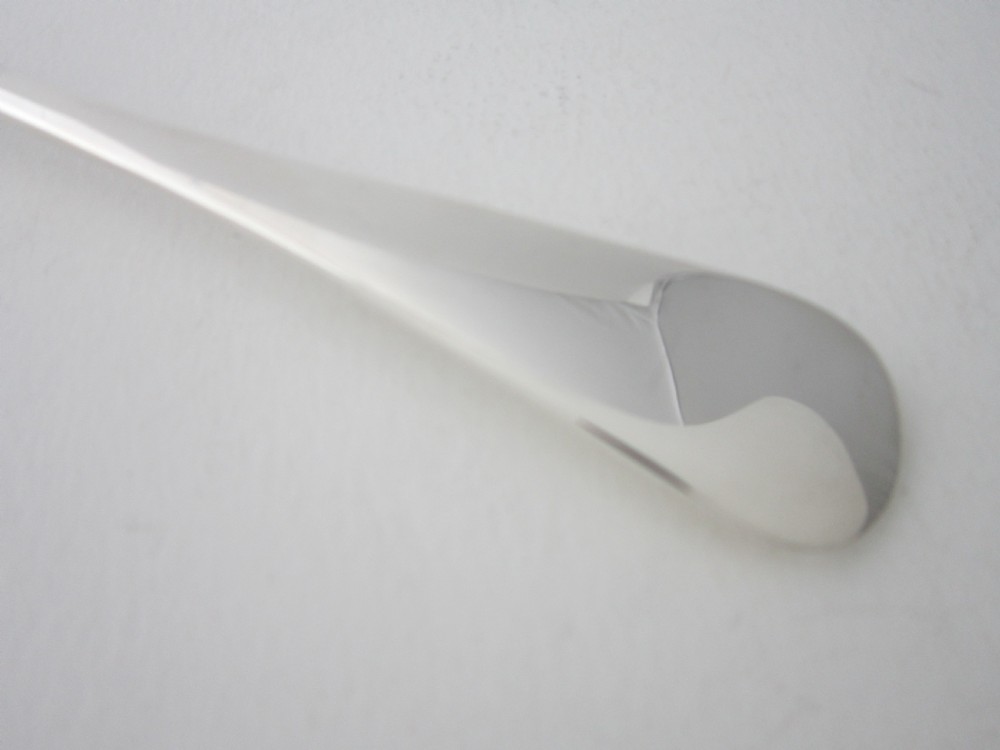 An antique sterling silver Stilton scoop featuring a curved spade-shaped blade and a smooth Old English pattern handle. View IV