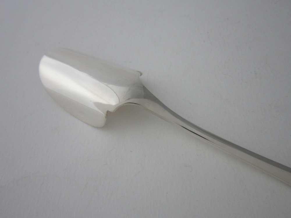 An antique sterling silver Stilton scoop featuring a curved spade-shaped blade and a smooth Old English pattern handle. View V