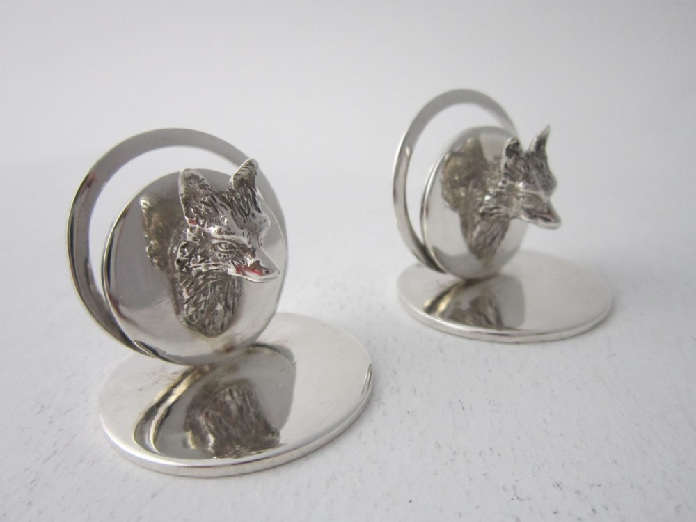 A pair of sterling silver place card holders featuring sculpted fox heads mounted on circular silver bases. View III