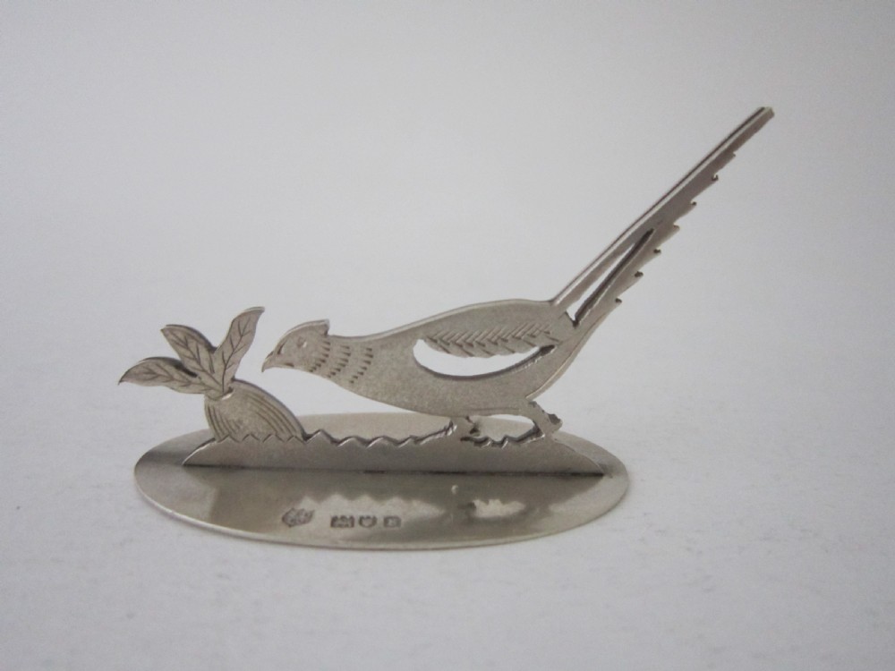 A pair of hallmarked sterling silver menu card holders featuring silhouetted pheasants set on oval bases. View IV