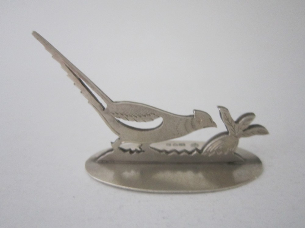 A pair of hallmarked sterling silver menu card holders featuring silhouetted pheasants set on oval bases. View V