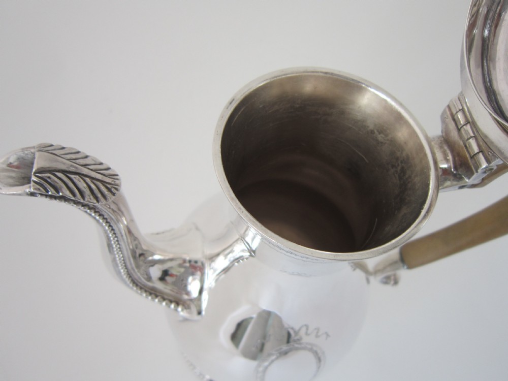 A five-piece sterling silver tea and coffee set featuring carved wooden handles, engraved oval cartouches, a teapot with stand, coffee pot, cream jug, and sugar basket. View VI