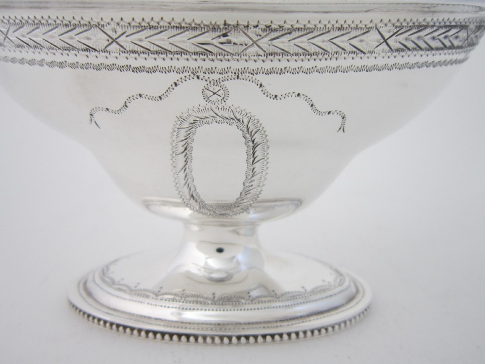 A five-piece sterling silver tea and coffee set featuring carved wooden handles, engraved oval cartouches, a teapot with stand, coffee pot, cream jug, and sugar basket. View XI