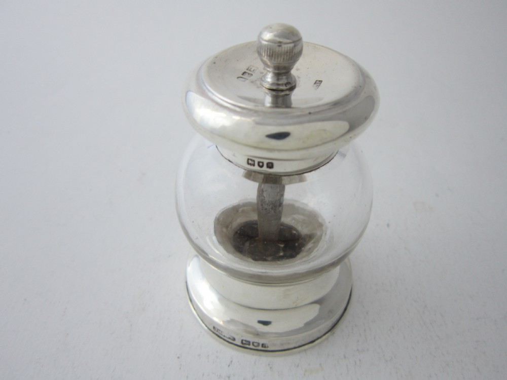 Victorian sterling silver and clear glass pepper grinder featuring hallmarked silver rims and a turned top knob. View II