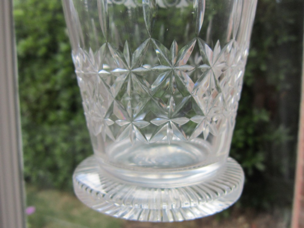 An antique Victorian claret jug featuring a clear etched glass body with cut geometric patterns and an engraved sterling silver collar and handle. View VIII