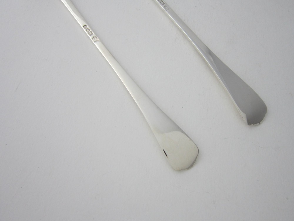 A pair of Edwardian sterling silver salad servers with chased foliate handles and shaped lobed bowls, dating to 1903. View VII