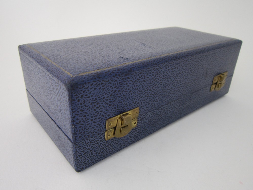 A three-piece sterling silver condiment set with textured bark-effect surfaces including a salt cellar, mustard pot, pepper shaker, and two spoons in a blue fitted case. View II