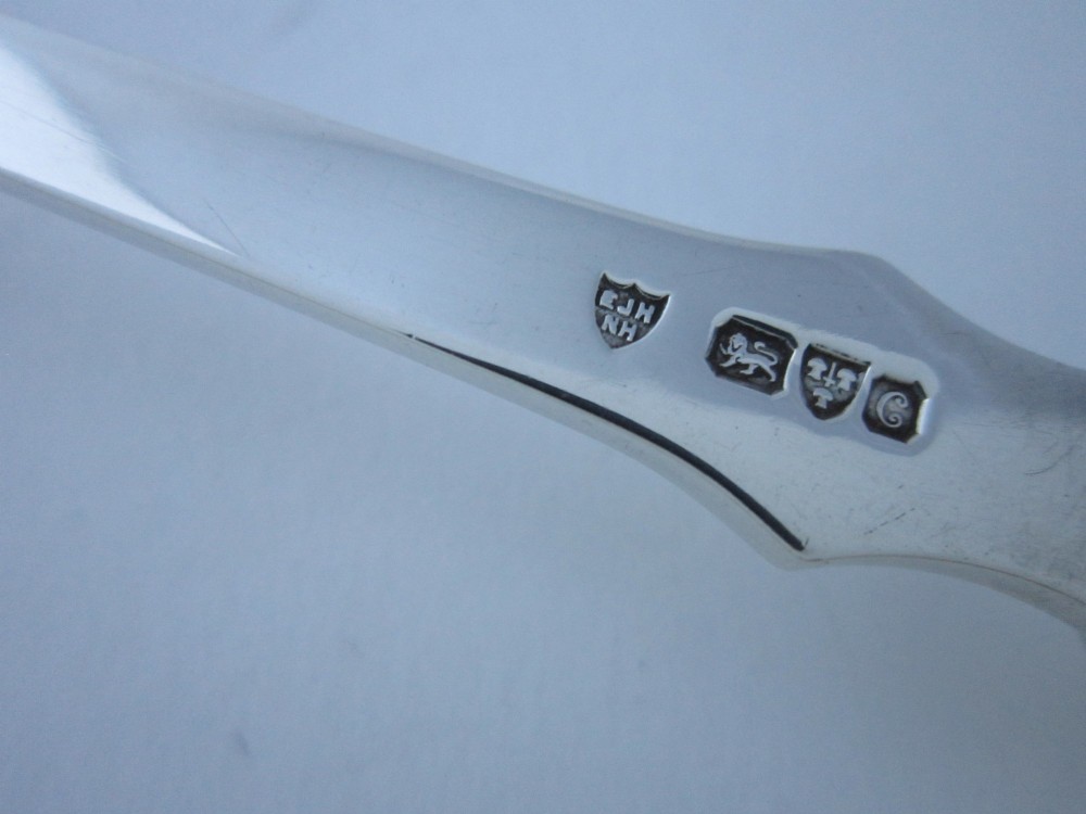 A pair of Edwardian sterling silver salad servers featuring faceted cut glass handles and rat tail detailing on the bowls. View VII