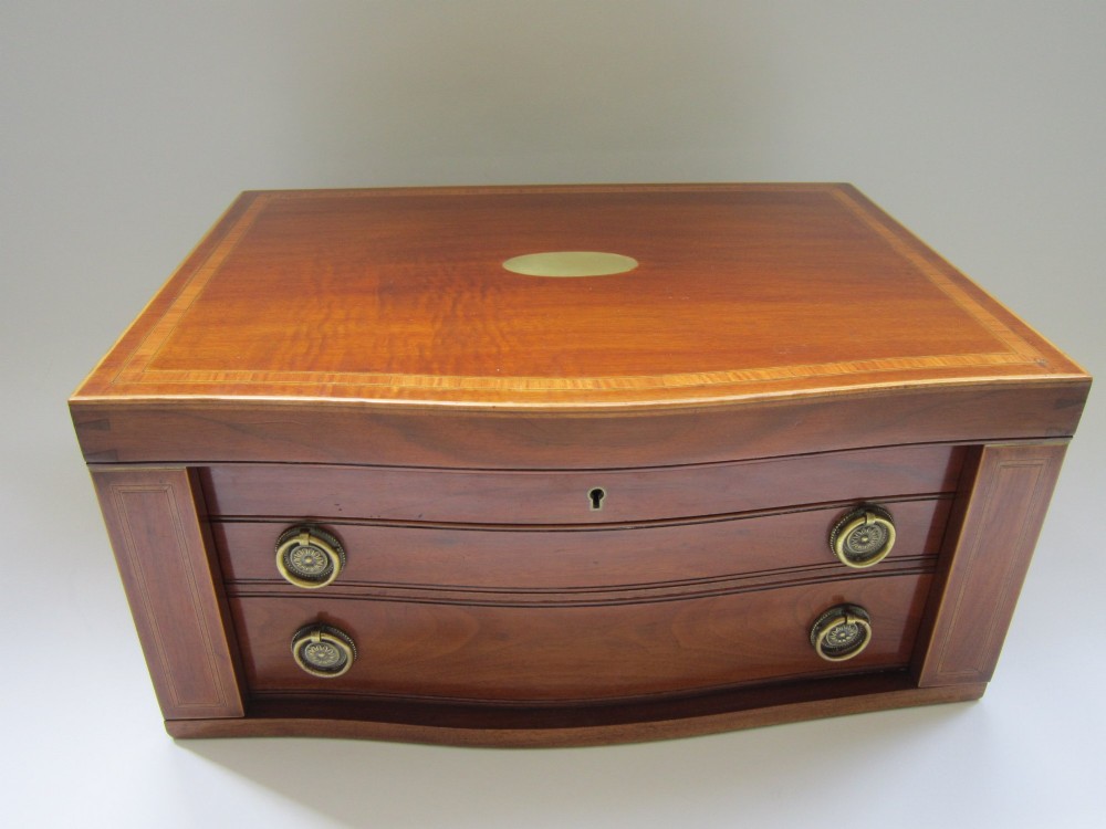 An open Victorian mahogany canteen chest fitted with drawers displaying a full sterling silver fiddle pattern cutlery service lined in green fabric. View II