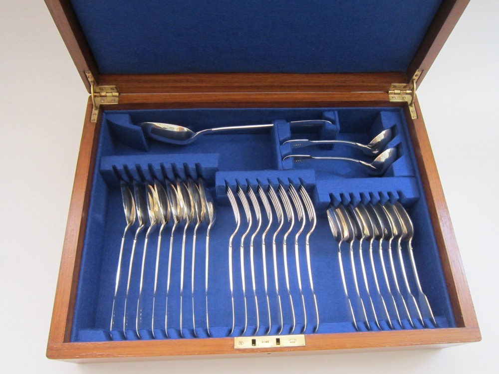 An open wooden canteen box lined with blue fabric displaying a complete set of Victorian sterling silver fiddle pattern cutlery. View III