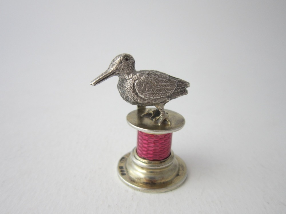 A set of four Edwardian sterling silver place card holders featuring pink guilloche enamel columns topped with sculpted game birds inside a fitted presentation box. View III