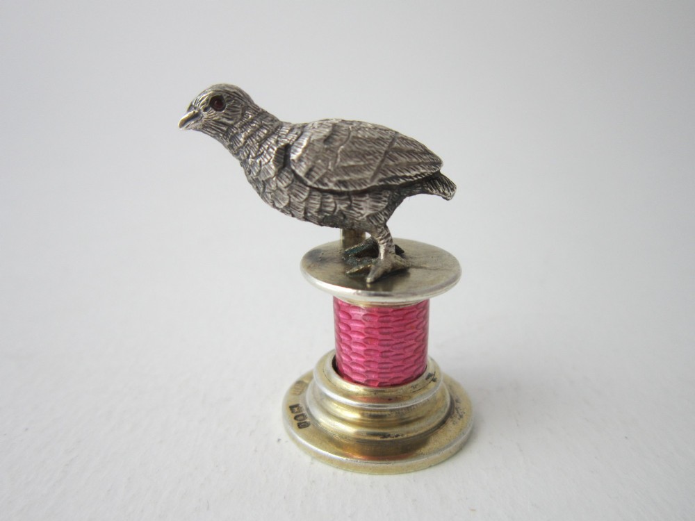 A set of four Edwardian sterling silver place card holders featuring pink guilloche enamel columns topped with sculpted game birds inside a fitted presentation box. View VIII