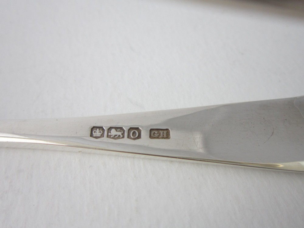 A pair of hallmarked sterling silver asparagus serving tongs with slotted blades resting inside a fitted presentation case. View VI
