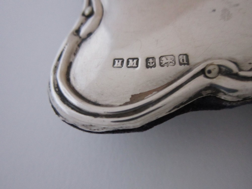 An Edwardian sterling silver photograph frame featuring sinuous Art Nouveau scrolls, a heart-shaped central aperture, and visible British hallmarks. View VII