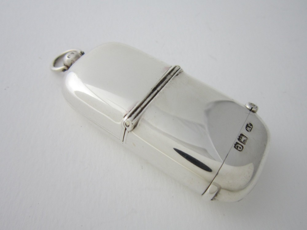 A late Victorian hallmarked sterling silver combination sovereign holder and vesta case shown open, featuring a spring-loaded coin mechanism and top suspension loop. View III