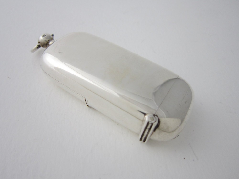 A late Victorian hallmarked sterling silver combination sovereign holder and vesta case shown open, featuring a spring-loaded coin mechanism and top suspension loop. View IV