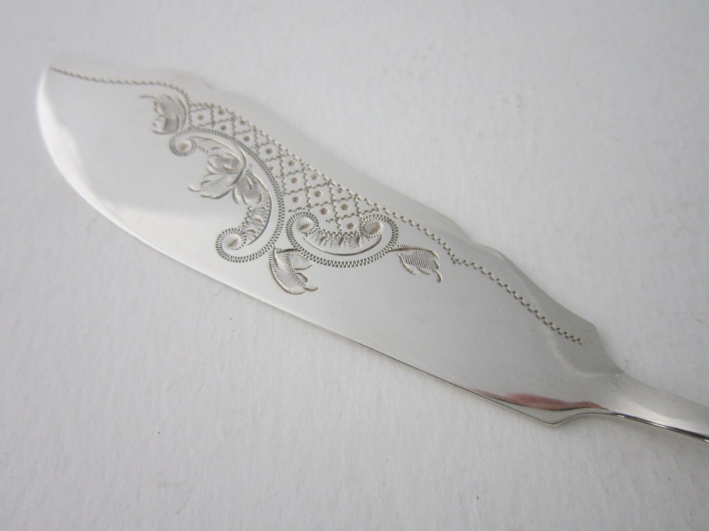 An Edwardian sterling silver butter knife with engraved scrollwork and foliate details on the blade and handle. View II