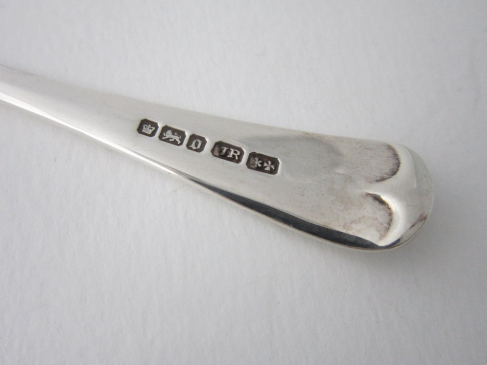 An Edwardian sterling silver butter knife with engraved scrollwork and foliate details on the blade and handle. View VI