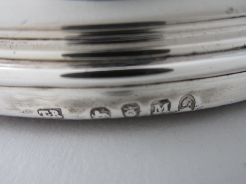 A pair of circular George III sterling silver wine coasters featuring turned wooden bases with central silver bosses and plain silver rims. View VI