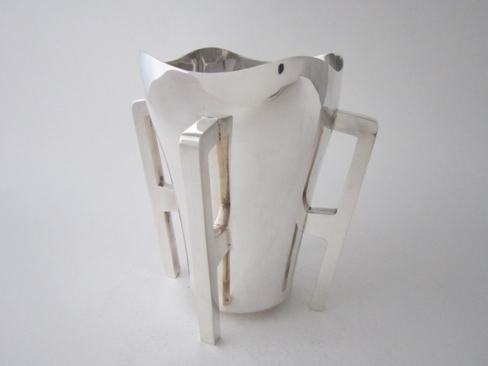 An Edwardian sterling silver mether cup featuring a square mouth and four angular handles that extend downward to form the feet. View II
