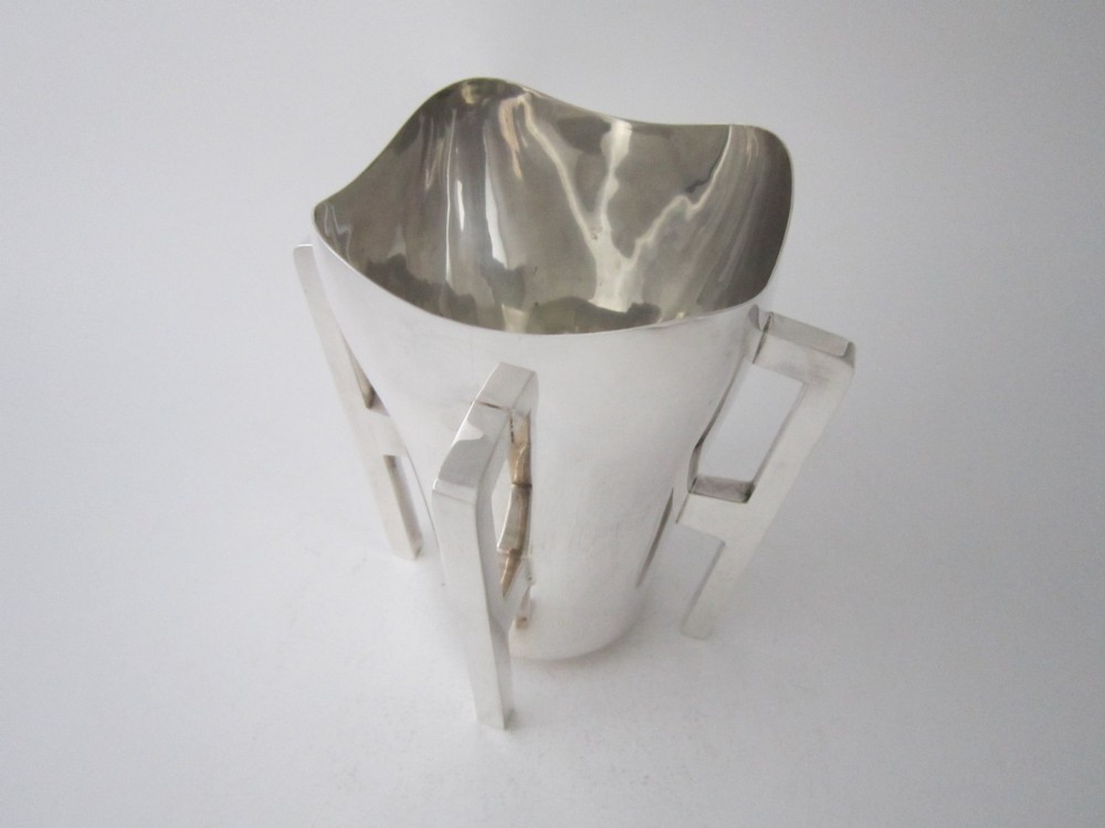 An Edwardian sterling silver mether cup featuring a square mouth and four angular handles that extend downward to form the feet. View III