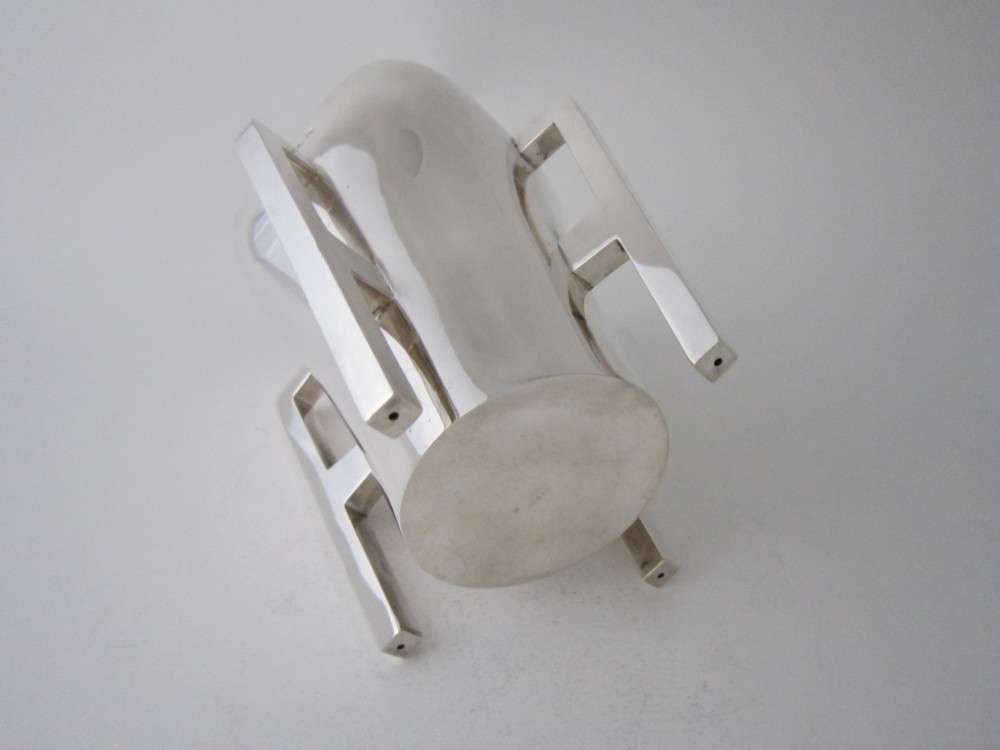An Edwardian sterling silver mether cup featuring a square mouth and four angular handles that extend downward to form the feet. View IV