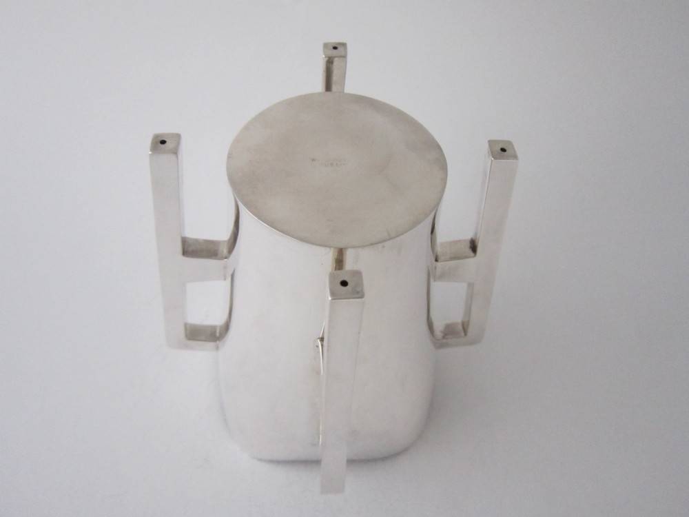 An Edwardian sterling silver mether cup featuring a square mouth and four angular handles that extend downward to form the feet. View V