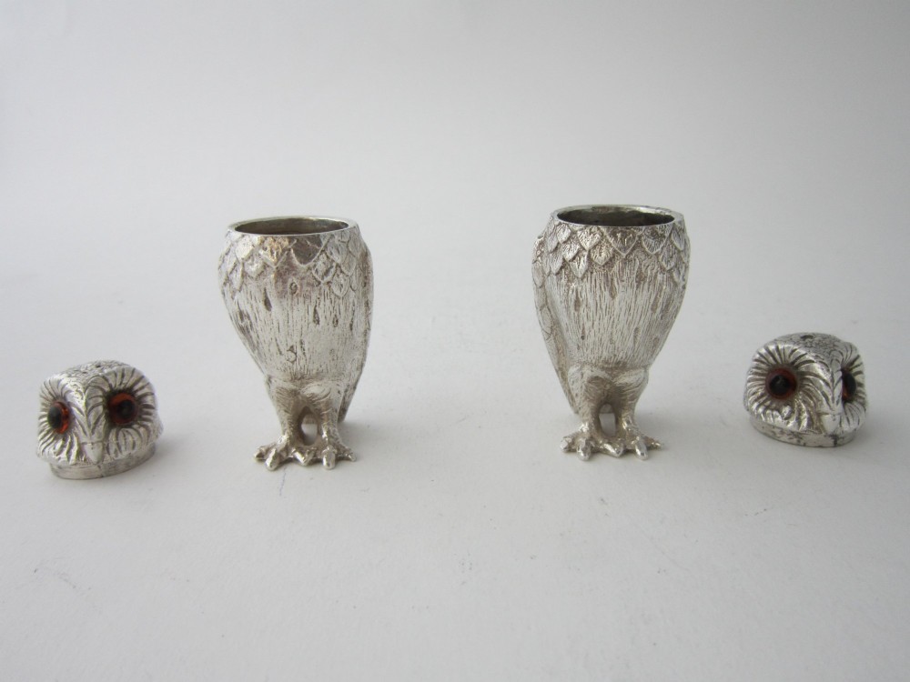 A pair of cast sterling silver salt and pepper shakers in the form of standing owls with textured feather detailing and dark amber glass eyes. View IV