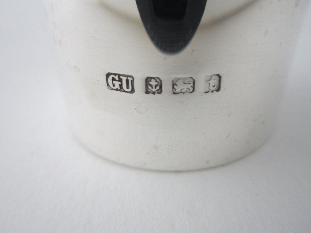 A plain cylindrical sterling silver napkin ring displaying a polished metallic finish. View IV
