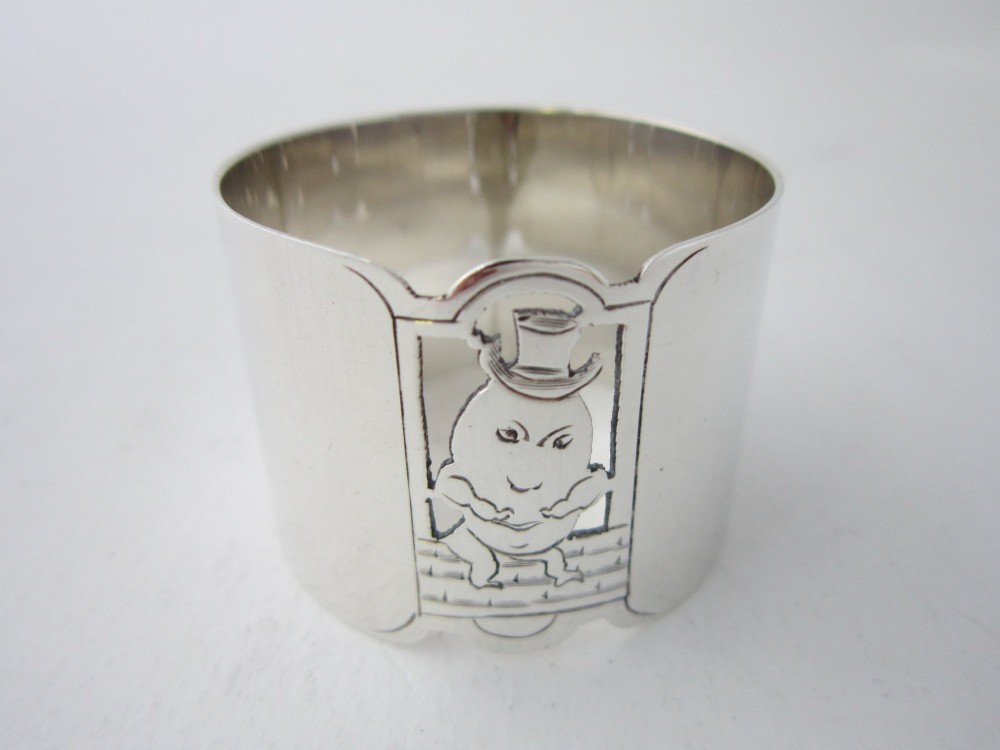 A sterling silver napkin ring featuring a pierced cutout motif of Humpty Dumpty wearing a top hat. View III