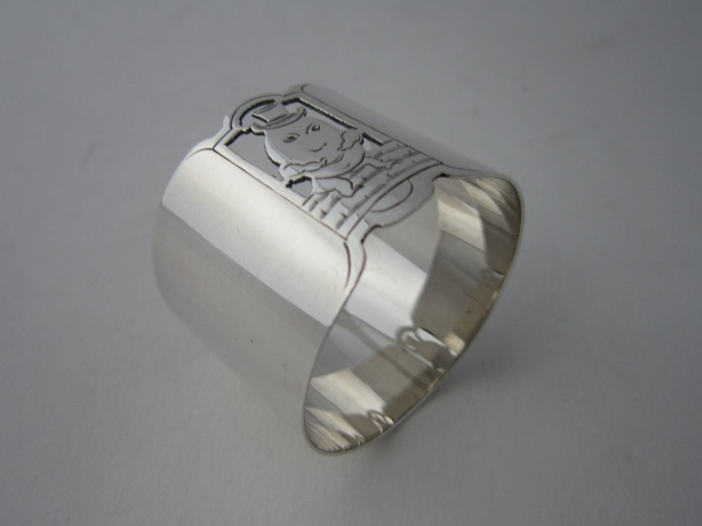 A sterling silver napkin ring featuring a pierced cutout motif of Humpty Dumpty wearing a top hat. View IV