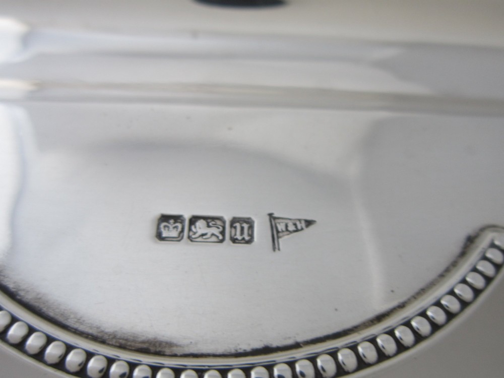 A George V sterling silver tray featuring a pierced gallery, scroll feet, a central pen recess, and two square cut-glass inkwells with silver lids. View XIII