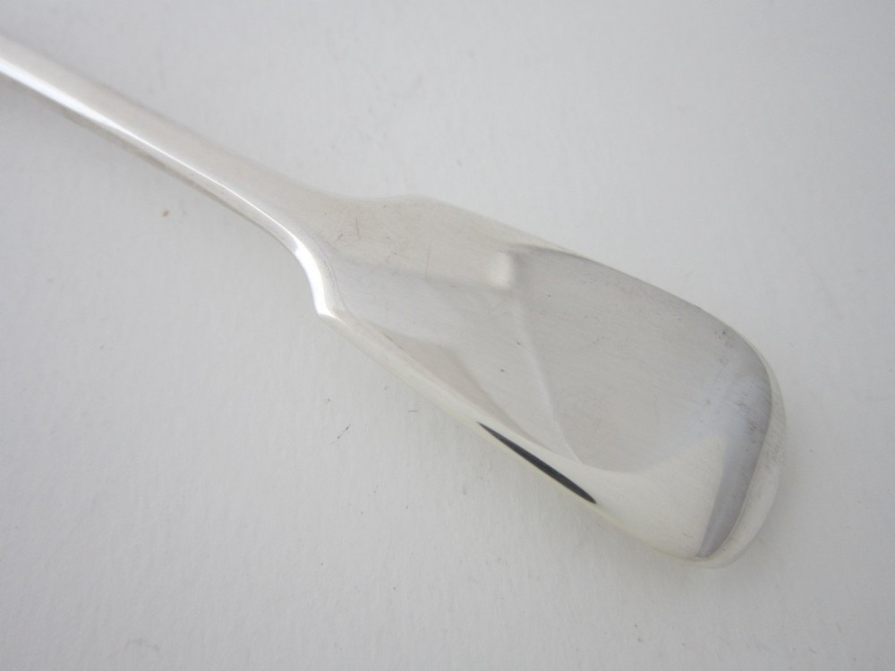 An antique Victorian sterling silver butter knife featuring a classic Fiddle pattern handle and a shaped spreading blade. View III