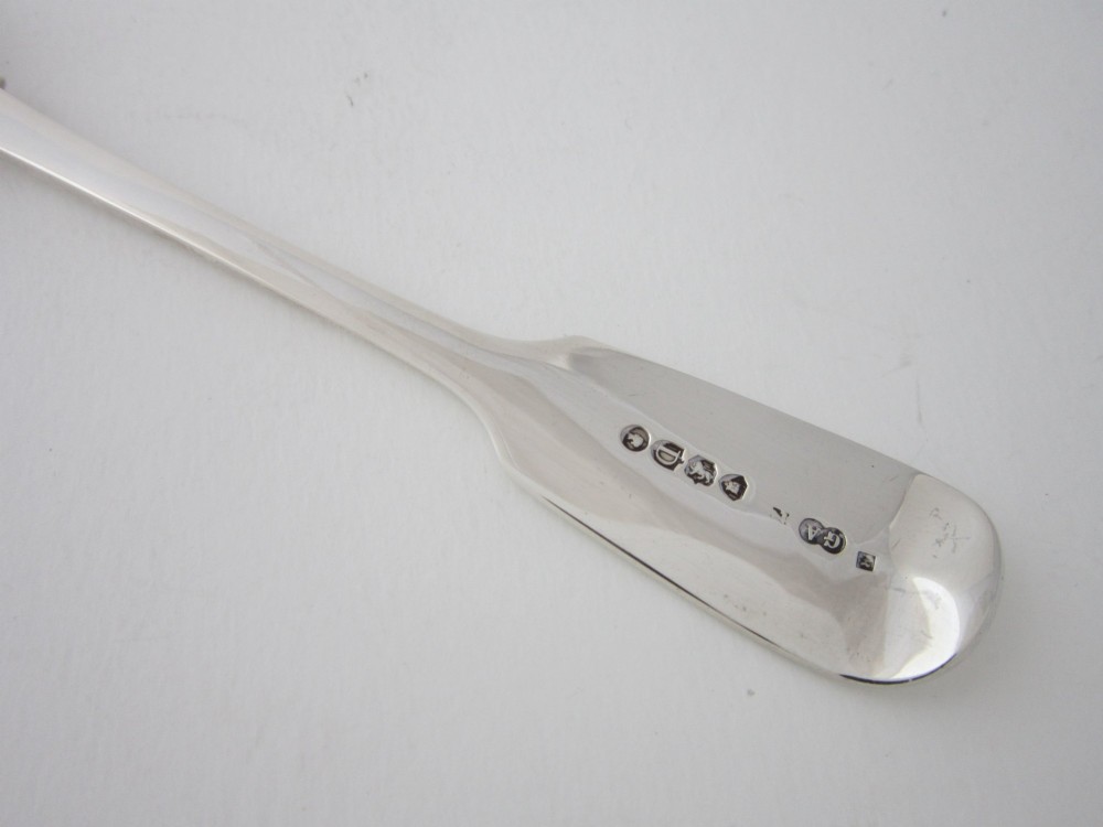 An antique Victorian sterling silver butter knife featuring a classic Fiddle pattern handle and a shaped spreading blade. View VI